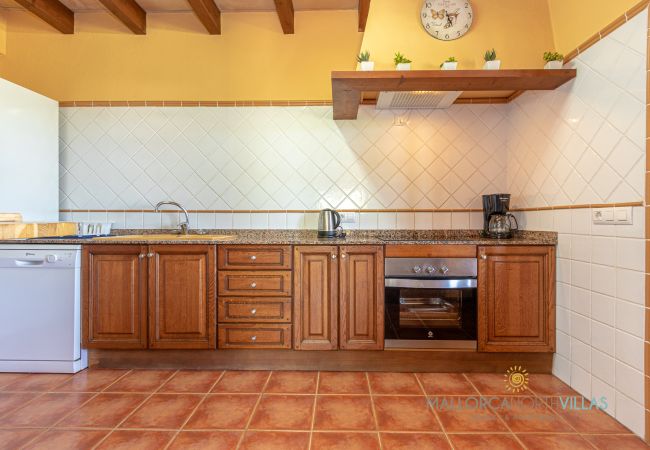 Rustic kitchen with wooden cabinets and appliances Rustic kitchen with wooden cabinets, oven, dishwasher and granite countertop