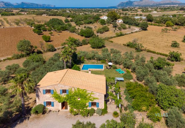 Aerial view of stone finca with pool and garden Aerial view of stone finca with private pool and Mediterranean garden in natural surroundings.