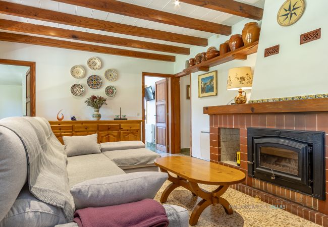 La Sort Llarga Living-Dining – Sofas and fireplace Pollença Sofas and fireplace in the living-dining room with Mallorcan decor at La Sort Llarga, Pollença