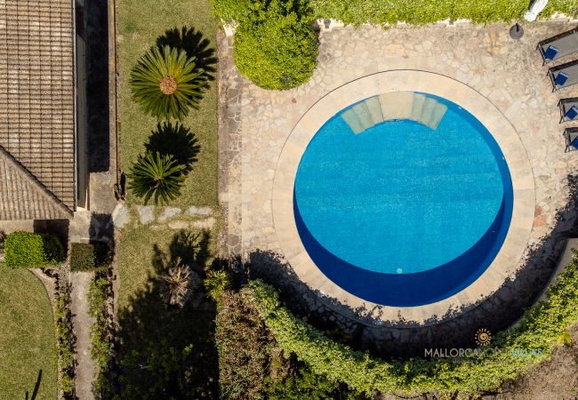 Round pool at La Sort Llarga aerial view Pollença Circular pool and garden at La Sort Llarga, Mallorca