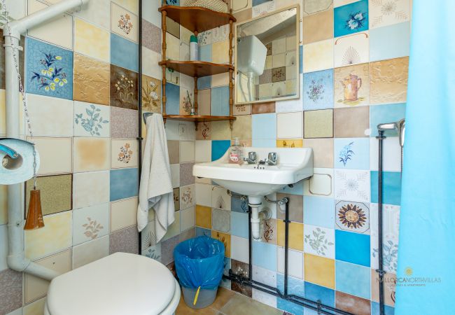 Bathroom with shower and colorful tiles at La Sort Llarga, Pollença Bathroom with toilet, sink, and shower at La Sort Llarga, Pollença