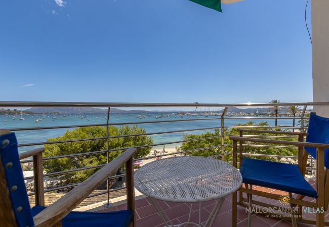 Balcony with Sea Views in Puerto Pollensa Balcony with blue chairs and table, sea and beach view in Pollensa