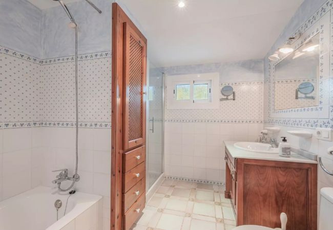 Spacious bathroom with wardrobe and bathtub Spacious bathroom with wardrobe and bathtub