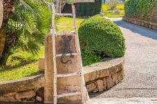 Entrance to the villa with a beautiful garden and parking area.