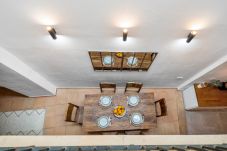 Top view of the dining room with wooden table for six and decorative mirror.